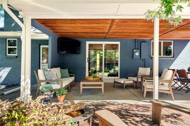 a outdoor space with patio the couches and a dining table with chairs and potted plants