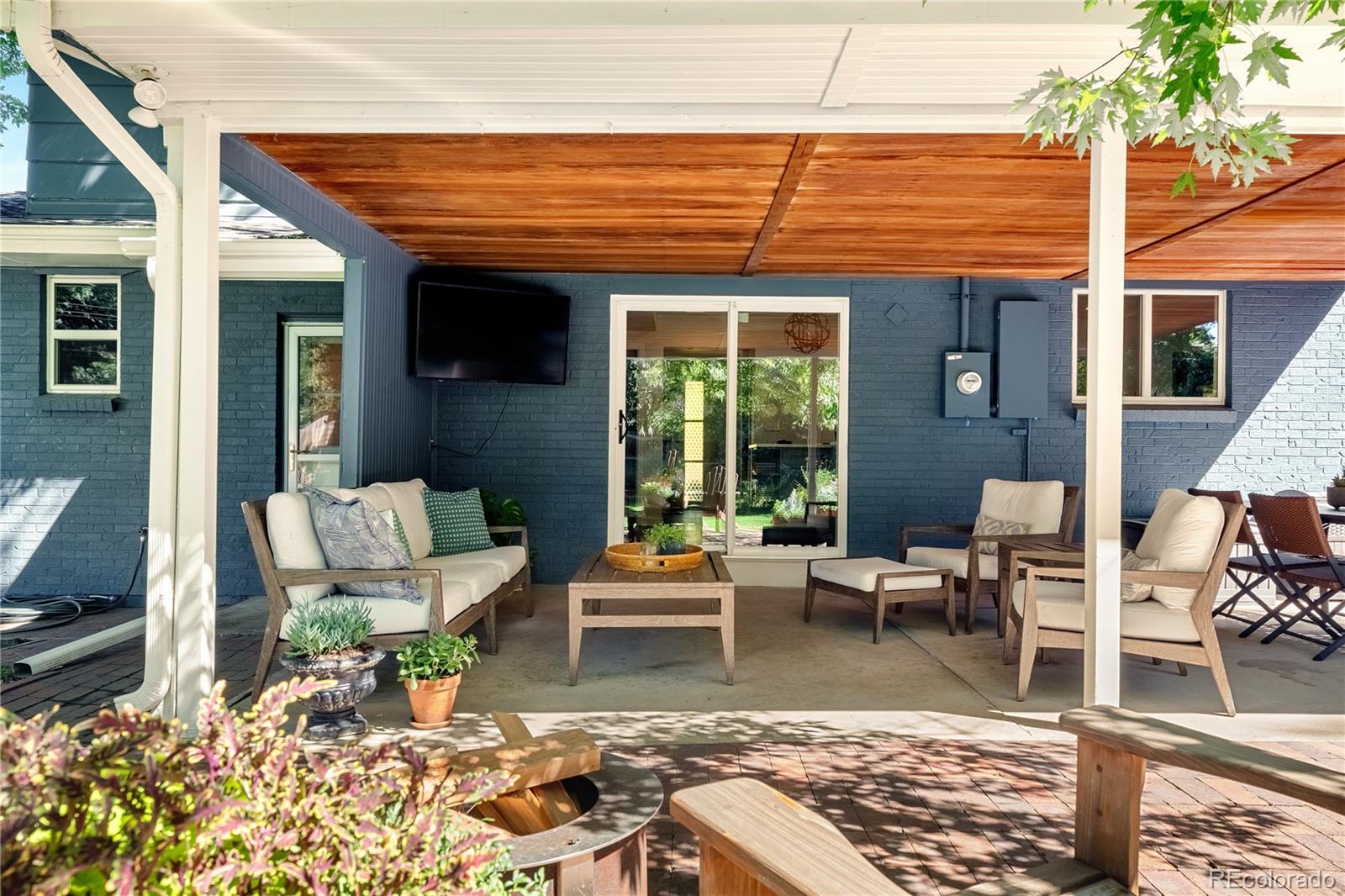 6149 South Elizabeth Way Centennial, CO 80121 - Photo 34 of 49 a outdoor space with patio the couches and a dining table with chairs and potted plants