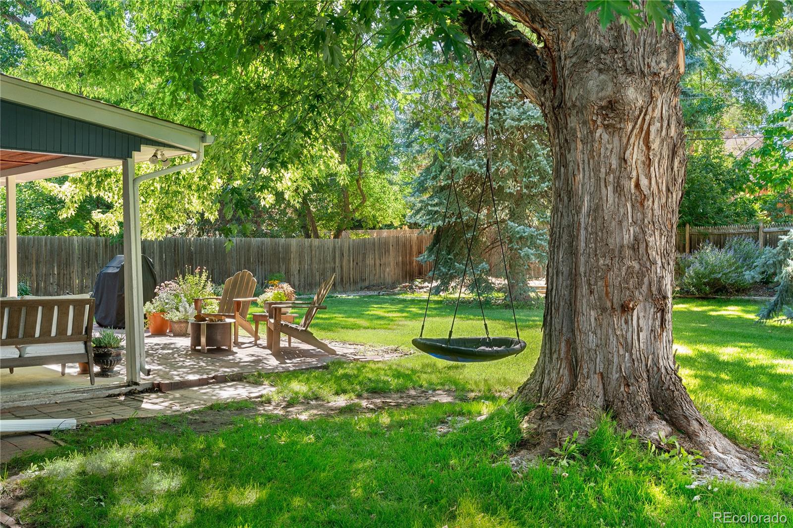 6149 South Elizabeth Way Centennial, CO 80121 - Photo 40 of 49 a view of a lake with a bench in a garden