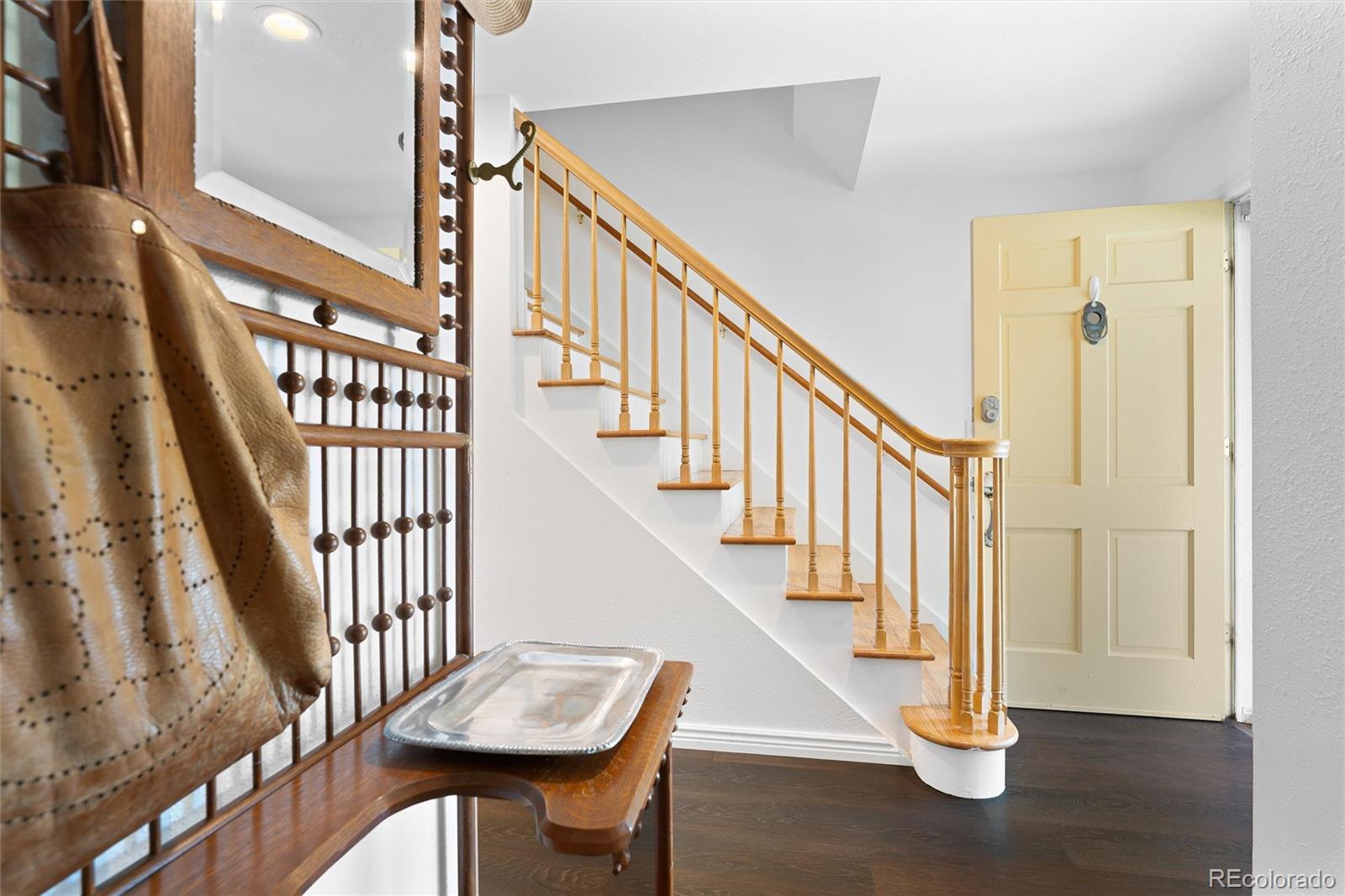 6149 South Elizabeth Way Centennial, CO 80121 - Photo 4 of 49 a view of entryway with wooden floor and stairs