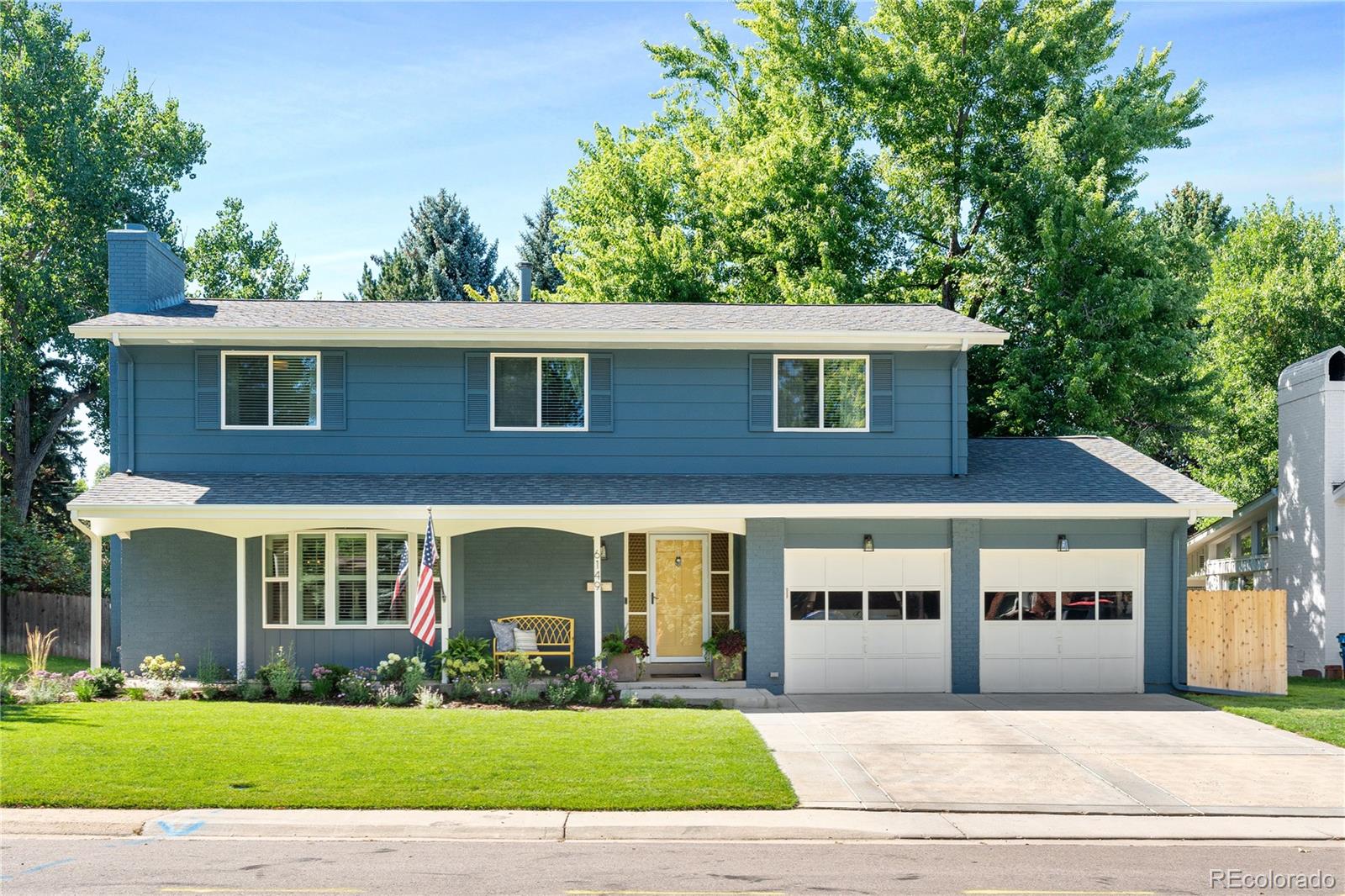 6149 South Elizabeth Way Centennial, CO 80121 - Photo 42 of 49 a front view of a house with a yard and potted plants
