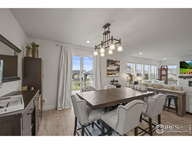 a view of a dining room with furniture and a chandelier