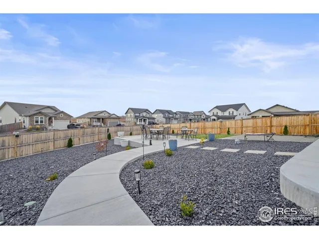 a view of a big house with a big yard and large trees