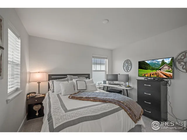 a bedroom with a bed and a ceiling fan