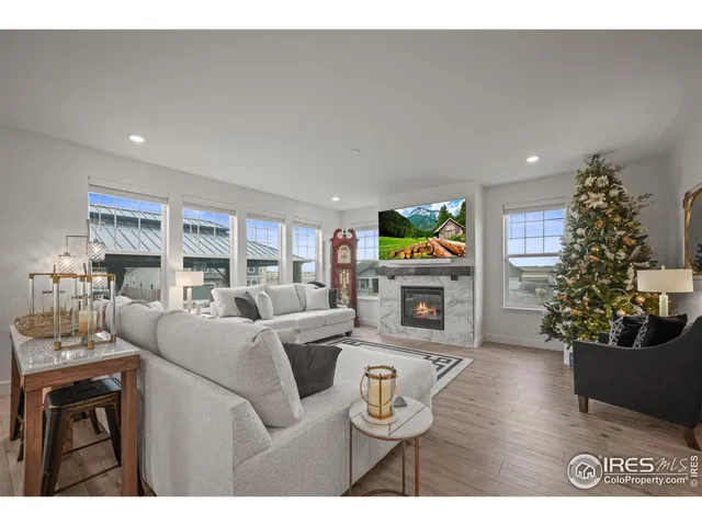 a living room with furniture a fireplace and a potted plant