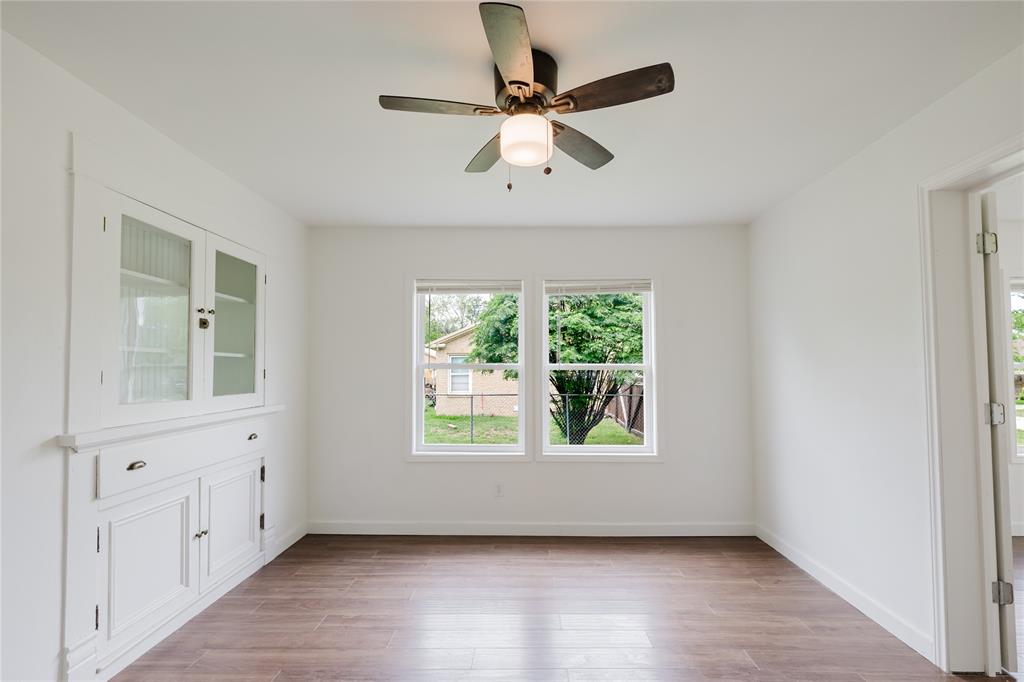 524 West Roberts Street Gorman, TX 76454 - Photo 13 of 35 an empty room with wooden floor fan and windows