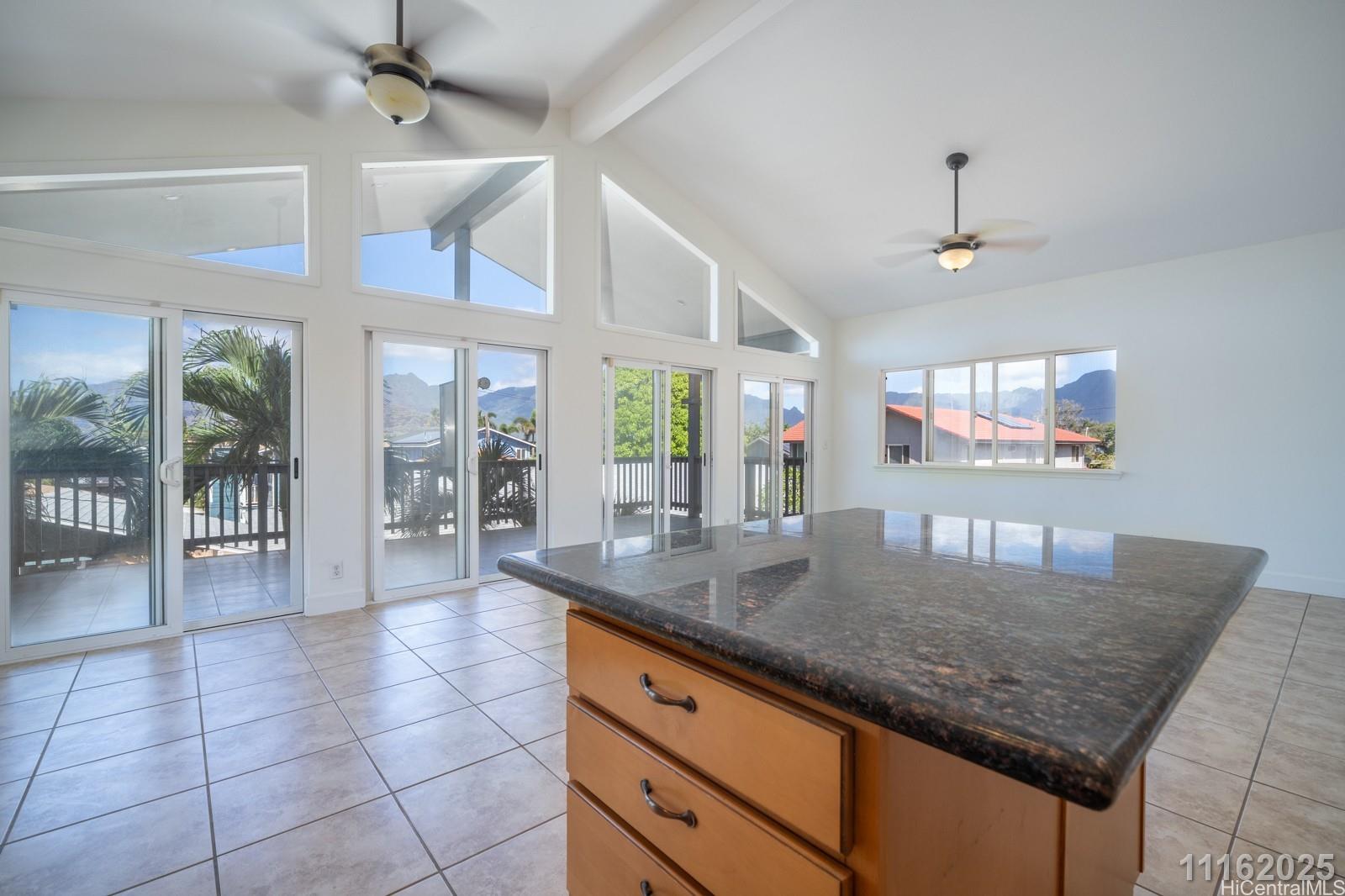 87-110 Kaukama Road, Unit B Waianae, HI 96792 - Photo 16 of 24 a kitchen with stainless steel appliances granite countertop a sink a counter top space and living room view