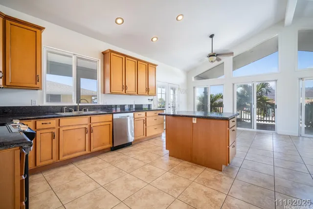 a kitchen with granite countertop a sink stove and cabinets