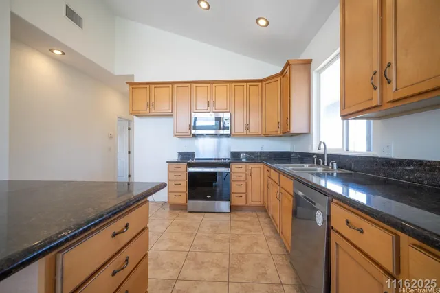 a kitchen with stainless steel appliances granite countertop a stove and a microwave