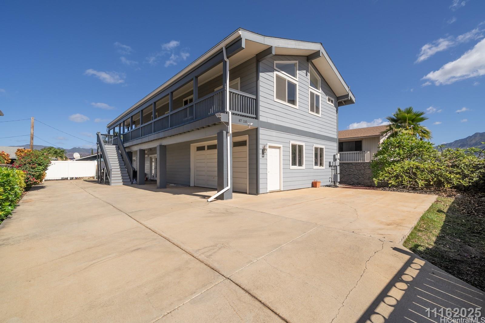 87-110 Kaukama Road, Unit B Waianae, HI 96792 - Photo 3 of 24 a front view of a house with a yard and potted plants