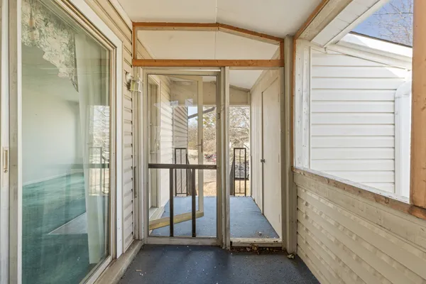 a view of a bathroom with a glass door and a window