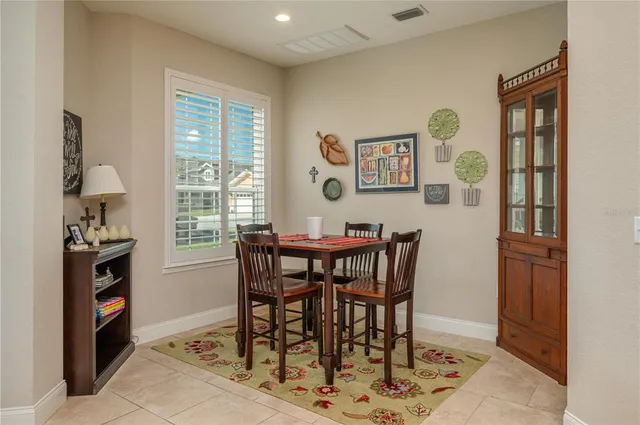 a view of a dining room with furniture and a window