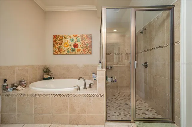 a bathroom with a tub a sink and glass door