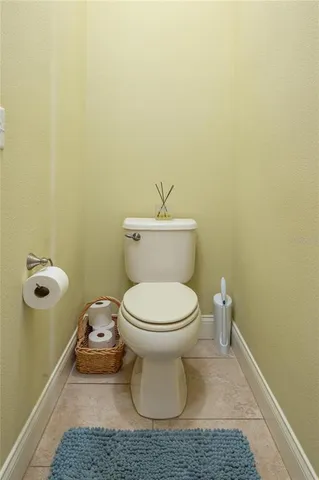 a white toilet sitting next to a bathroom sink