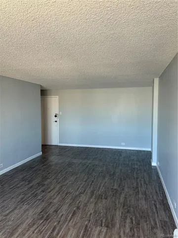 a view of an empty room and wooden floor