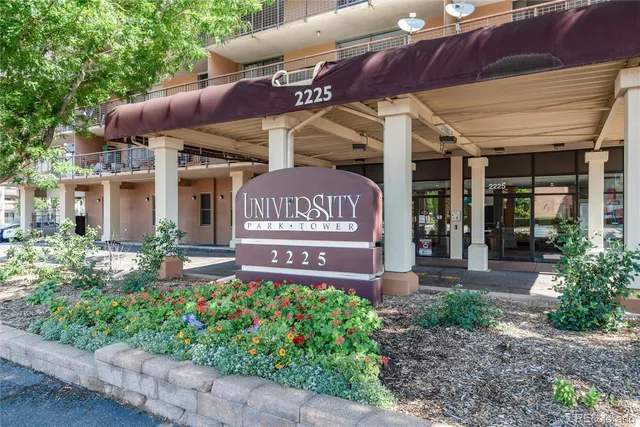 a view of a cafe with a table and chairs under an umbrella