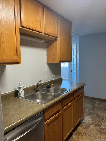 a kitchen with sink and cabinets