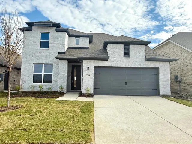 a front view of a house with a garage
