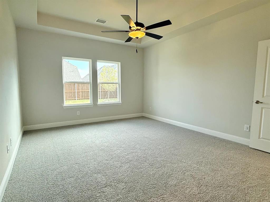 2708 Shiners Street Forney, TX 75126 - Photo 13 of 25 an empty room with windows and a ceiling fan