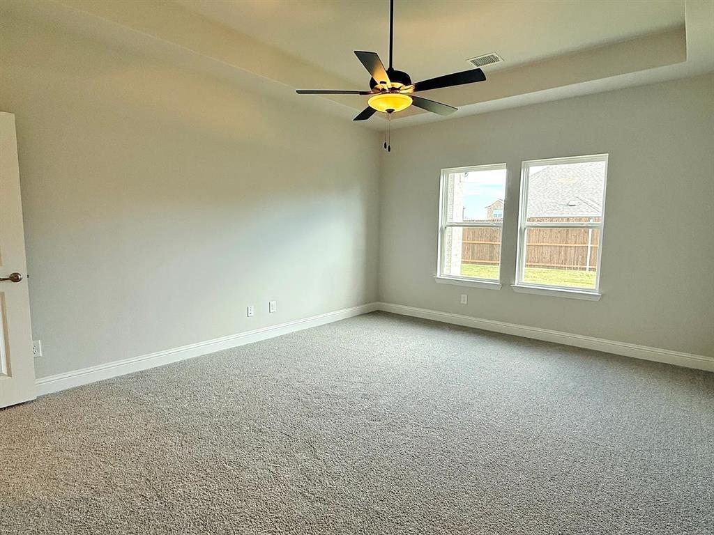 2708 Shiners Street Forney, TX 75126 - Photo 14 of 25 an empty room with a window and a fan