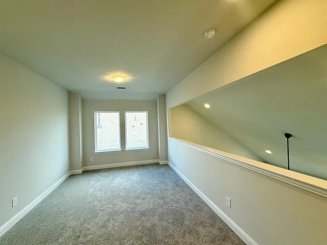 a view of a room window and a ceiling fan