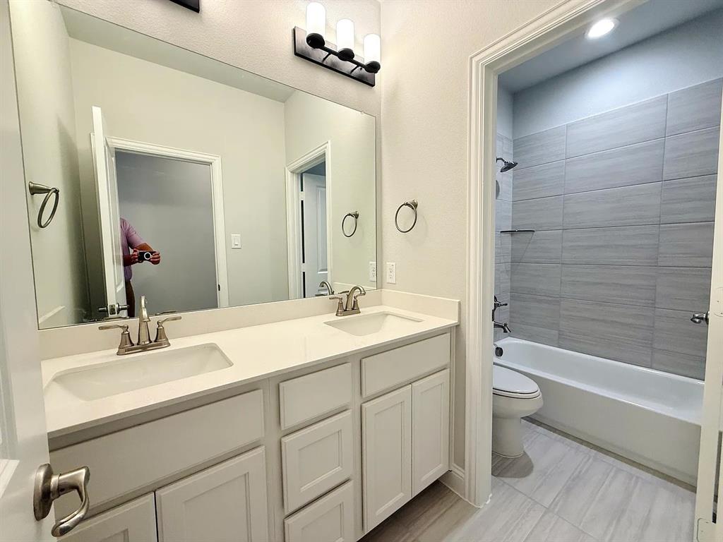 2708 Shiners Street Forney, TX 75126 - Photo 20 of 25 a bathroom with a double vanity sink toilet and shower