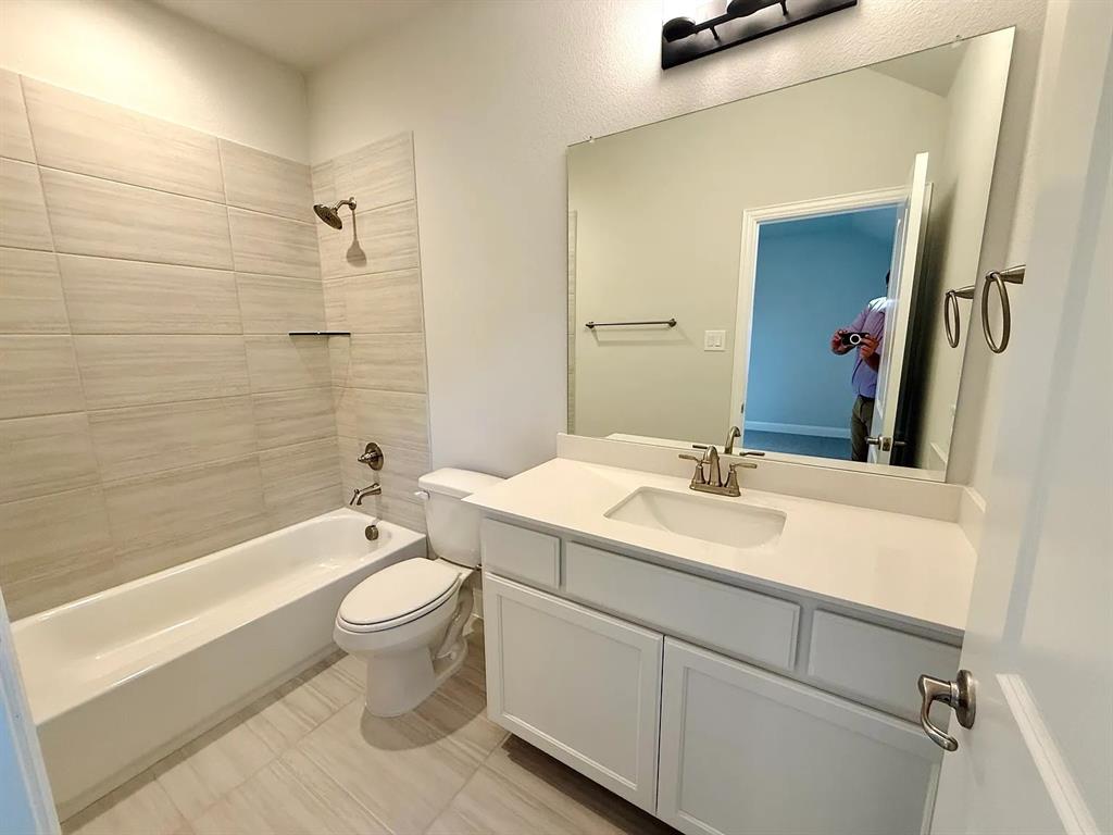 2708 Shiners Street Forney, TX 75126 - Photo 22 of 25 a bathroom with a sink a toilet and shower