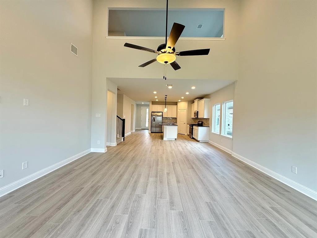 2708 Shiners Street Forney, TX 75126 - Photo 3 of 25 a view of a house with wooden floor and a ceiling fan