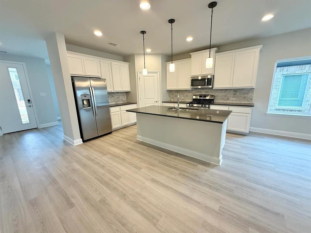 2708 Shiners Street Forney, TX 75126 - Photo 7 of 25 a kitchen with stainless steel appliances granite countertop a refrigerator a stove a sink and a oven