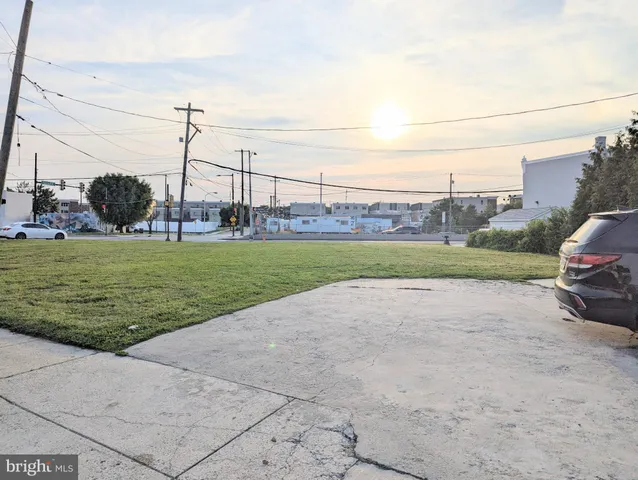 a view of a garden with a car park