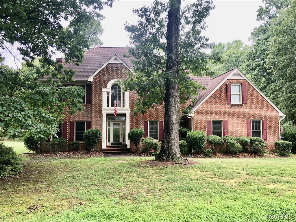 13002 Rockridge Road Chester, VA 23831 - Photo 1 of 49 a front view of a house with garden