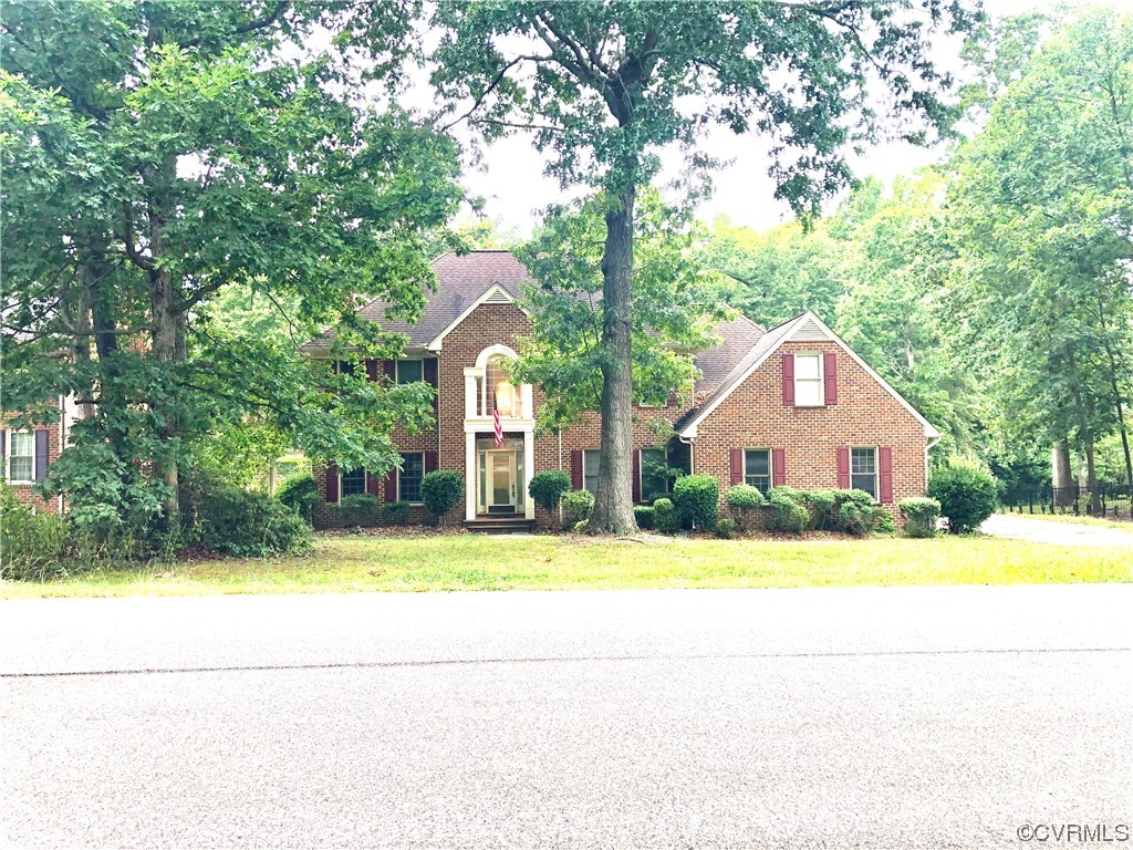 13002 Rockridge Road Chester, VA 23831 - Photo 6 of 49 a front view of a house with a yard and trees
