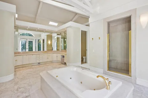 a bathroom with a bathtub and a shower