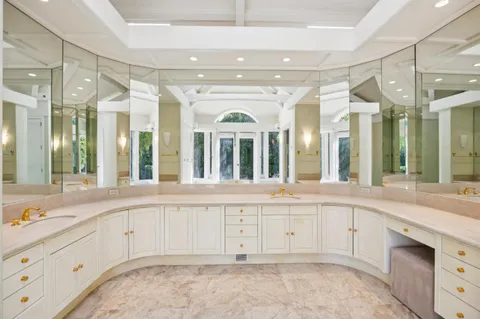 a large white kitchen with a large window