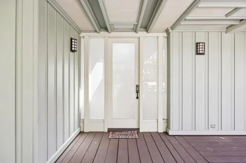 a view of a hallway with wooden floor and staircase