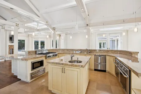 a kitchen with a stove sink and cabinets