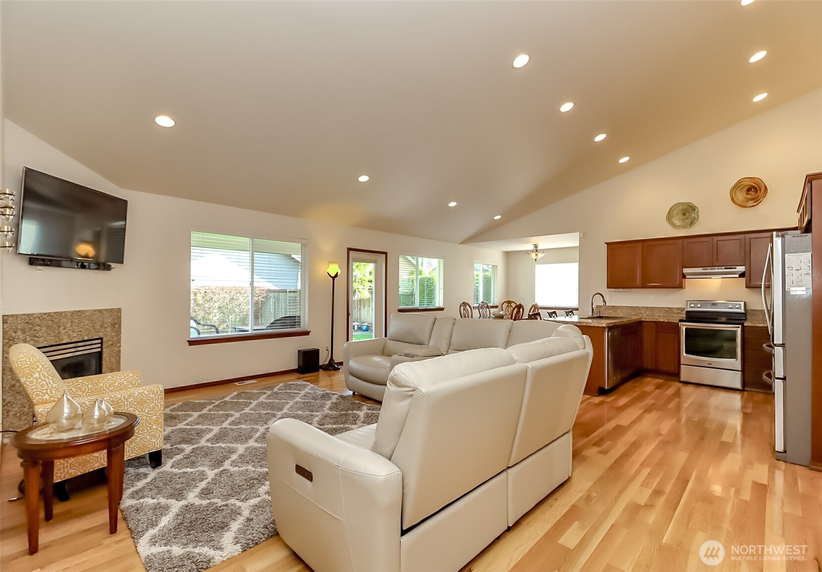 315 Dennis Way Monroe, WA 98272 - Photo 10 of 37 a living room with furniture a flat screen tv and kitchen view