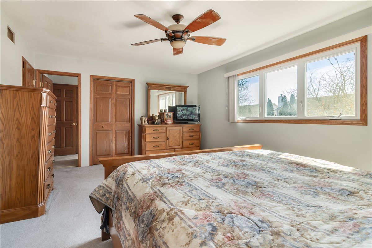 16641 West Oneida Drive Lockport, IL 60441 - Photo 13 of 24 a bedroom with a large bed and a window