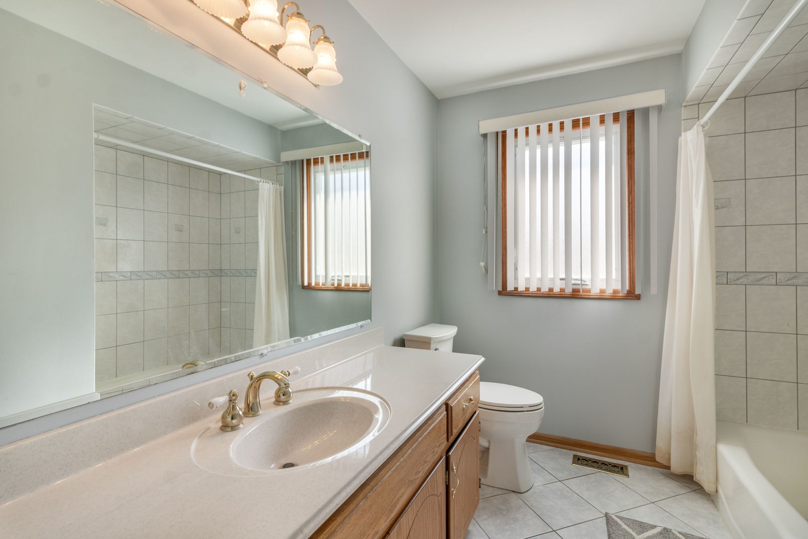 16641 West Oneida Drive Lockport, IL 60441 - Photo 14 of 24 a bathroom with a sink a toilet and a mirror