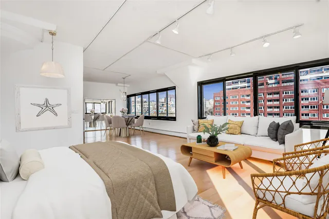 a living room with furniture a view and large windows