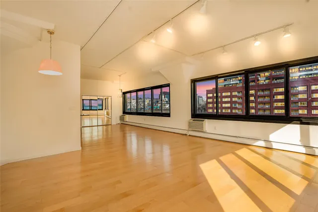 a view of empty room with window and fireplace