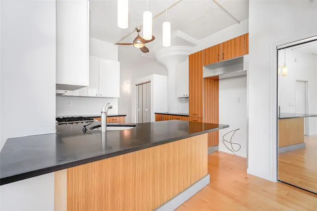 a view of an empty room with window and cabinet