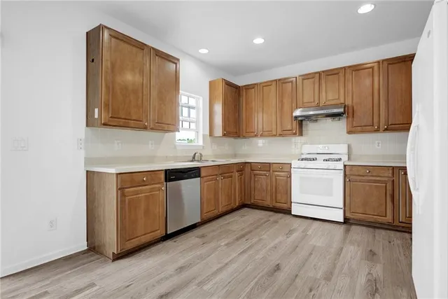 a kitchen with sink a microwave and cabinets