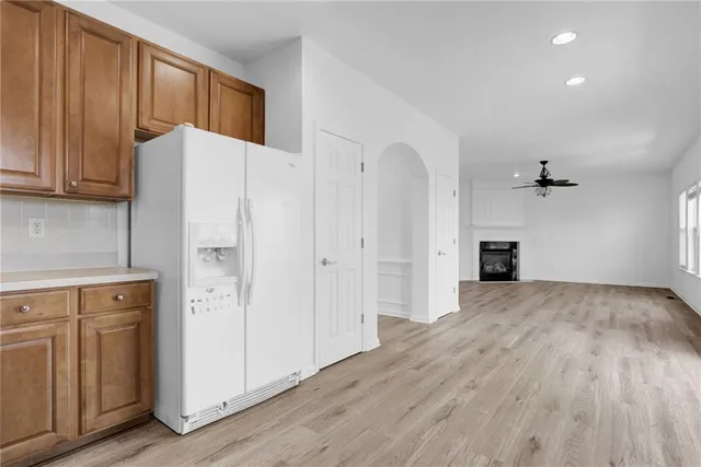 a view of an empty room with a kitchen