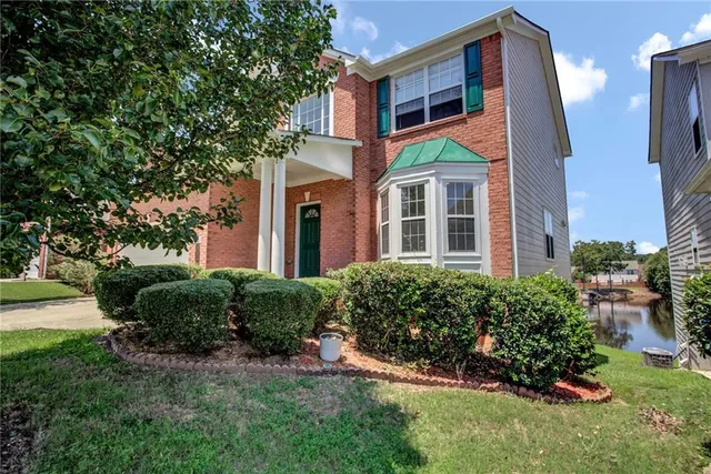 a front view of a house with a yard