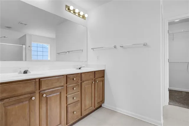 a spacious bathroom with a sink mirror and shower