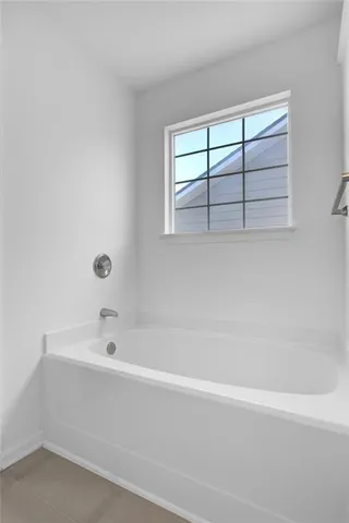 a bathroom with a bathtub and window