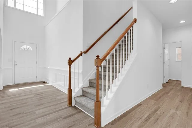 a view of hallway with stairs and wooden floor