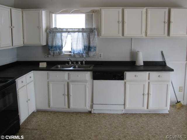 2390 Sheppard Town Road Maidens, VA 23102 - Photo 3 of 12 a kitchen with granite countertop white cabinets and white appliances