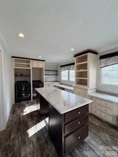 a kitchen with a stove a refrigerator and cabinets